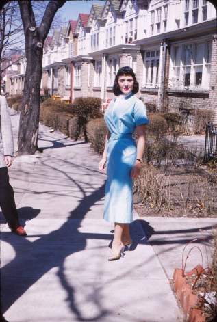 Mom posing in front her house before leaving for her ninth grade graduation in 1954